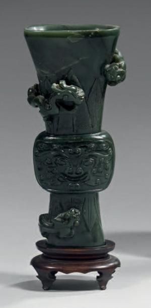 CHINE - XIXème siècle Vase de forme "gu" en serpentine verte à décor de masques de...
