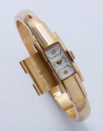 AUREOLE Montre bracelet de dame en or, cadran caché argenté avec index bâtons appliqués...