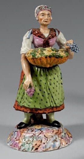 ALLEMAGNE ou SUISSE ALLEMANIQUE Figurine représentant une marchande de fruits tenant...