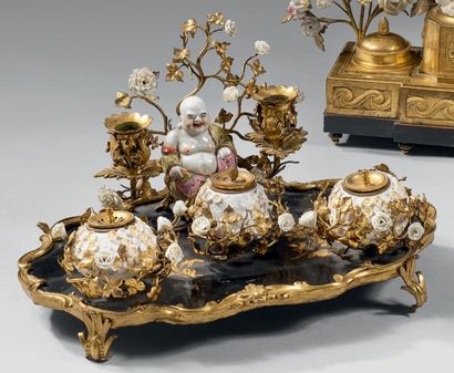 null Encrier en bronze doré, porcelaine et laque; le pla­teau comporte un bougeoir...