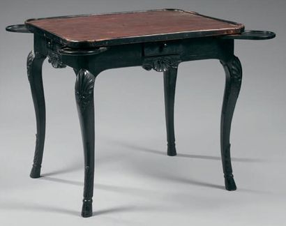 null Table à jeux en bois mouluré, sculpté et noirci; le plateau regainé est supporté...