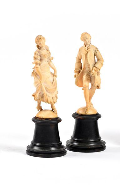 null Pair of carved ivory subjects representing a couple of elegant 18th century...