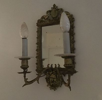 null Pair of gilded metal wall lights and mirror backdrop, with two light arms. Louis...