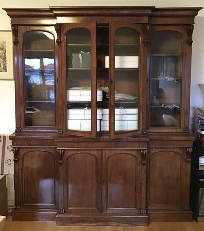 null An important mahogany bookcase moulded with foliated scrolls, it opens with...