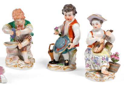 null Three polychrome porcelain subjects representing a grape-eater, a flower merchant...