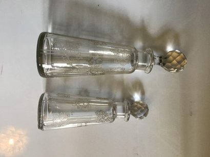 null BACCARAT, two engraved crystal bottles with fruit decoration.

Caps fitted....