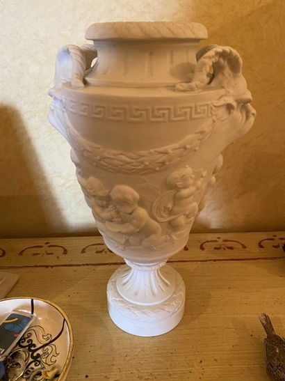 null Biscuit vase decorated with children playing after Clodion. Height 31cm