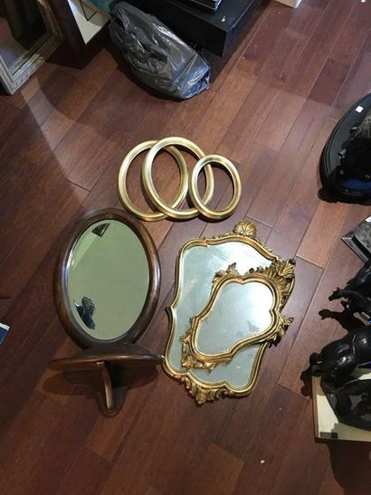 null Set including two gilded wooden mirrors in rocaille style, a saddle mirror in...