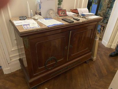 null Mahogany sideboard opening by two doors, decorated with chased bronze, the front...
