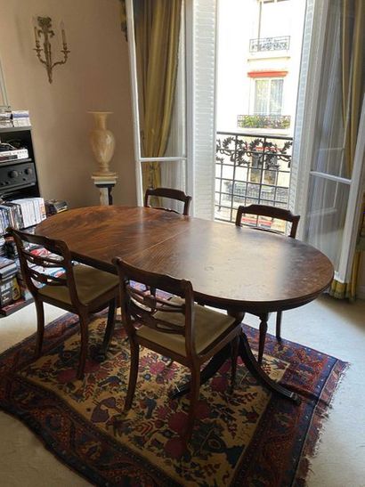 null Mahogany oval-shaped wooden dining table with two tripod legs finished with...