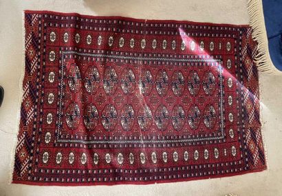 null Bukhara carpet with gulhs on a red background