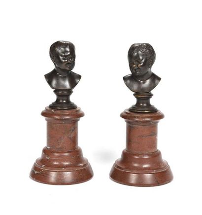 null 74 Two children's heads of character in patinated bronze resting on a marble...