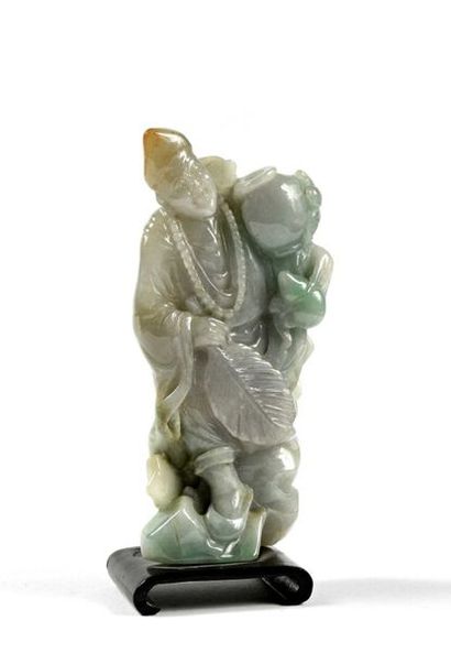 null 82 A celadon nephrite subject representing a man holding vases and a fan. China....