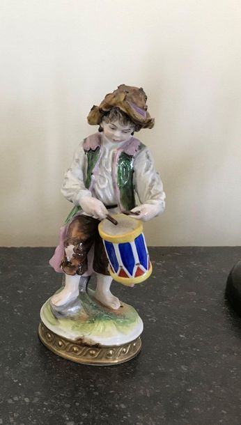 null Polychrome porcelain subject Young man with a drum Mark on the reverse side...