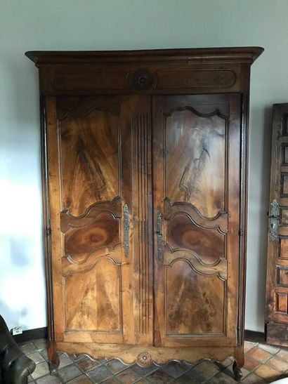 null Large moulded walnut cupboard carved with foliated rosettes opening by two doors,...