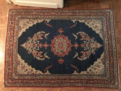 null Wool carpet decorated with a blue central medallion on a red background (wears...