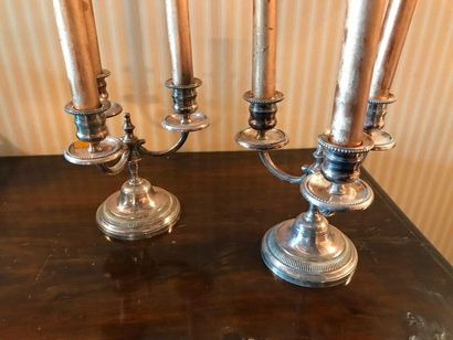null Pair of candelabra in silver plated metal base with grooved doucine and three...