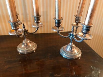 null Pair of candelabra in silver plated metal base with grooved doucine and three...