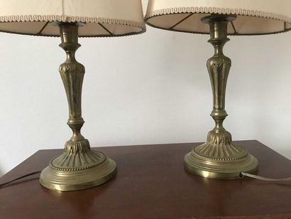 null Pair of gilt bronze candleholders decorated with flutes and pearls. Pierced...