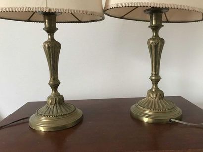 null Pair of gilt bronze candleholders decorated with flutes and pearls. Pierced...
