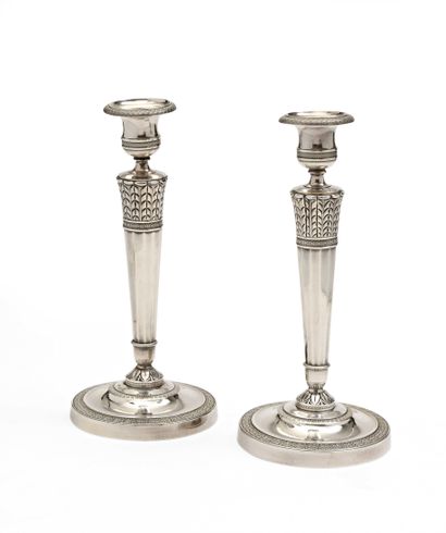 null 135 Pair of silver plated torches with quiver shaped shaft and circular base....