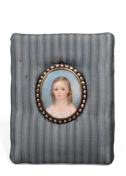 null 214 Oval miniature Portrait of a young girl mounted in gold with ½ pearl frame....