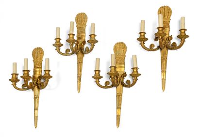 null 288 A set of four ormolu sconces with three arms of light decorated with quivers....