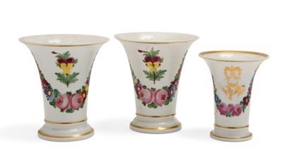 null 125 A pair of small white and gold porcelain cornet vases decorated with polychrome...