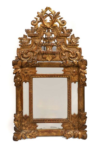 null 233 Small mirror with gilded wood glazing, the pediment carved with a flowering...