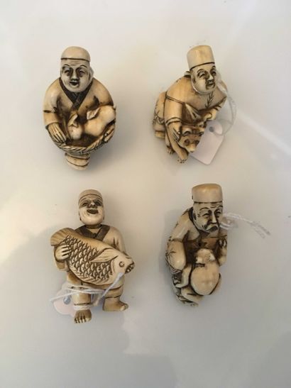 null Set of 4 ivory netsuke representing 4 characters holding a frog, a carp, a teddy...