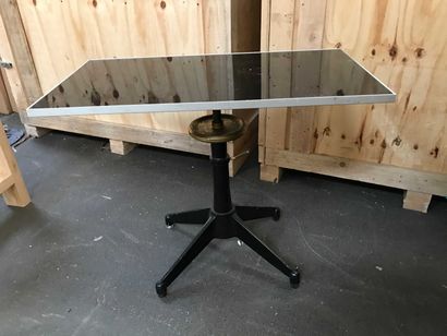 null Table with cast iron legs and adjustable top in tinted glass