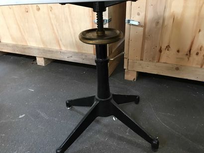 null Table with cast iron legs and adjustable top in tinted glass