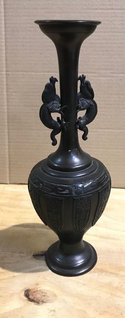 null Bronze vase with two stylized animal handles.