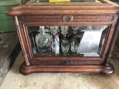 null 47 Wood and glass liquor cabinet with foliage and half-columns on the uprights....