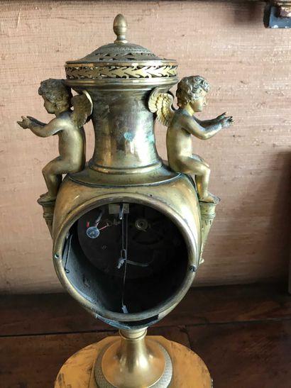 null Pendule en forme de vase balustre en bronze doré à décor deux angelots, corne...