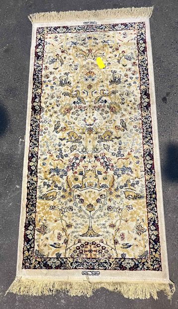 null Turkish carpet presenting the tree of life and animals on ivory background....