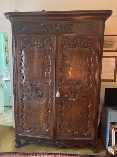 null Chestnut cabinet molded and richly carved with Rocaille decoration. Regional...