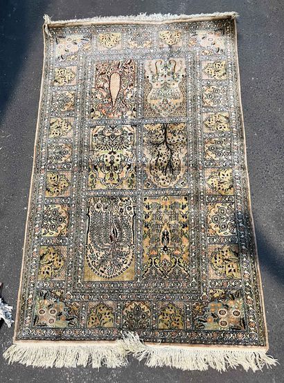 null Carpet with floral motifs in rectangular reserves on a green background. 164...