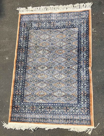 null Carpet with geometrical patterns on a blue background. 125 x 73 cm