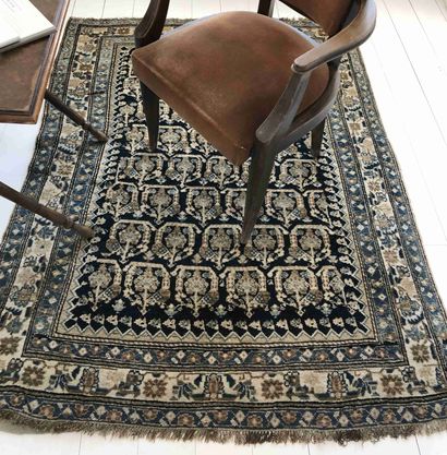 null Mechanical carpet with flowered decoration on blue bottom.