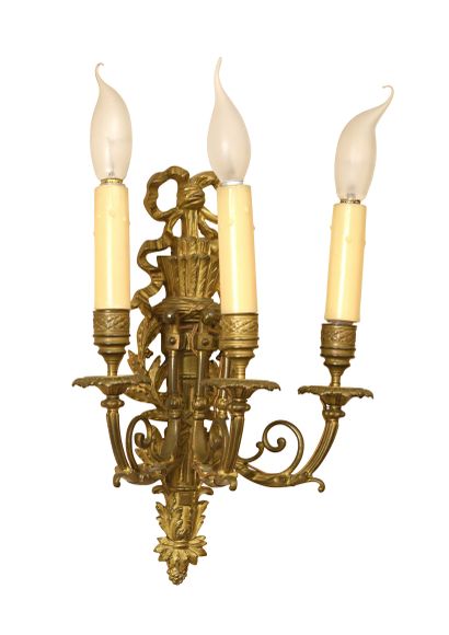 null Pair of sconces in chased and gilded bronze with three arms of light escaping...