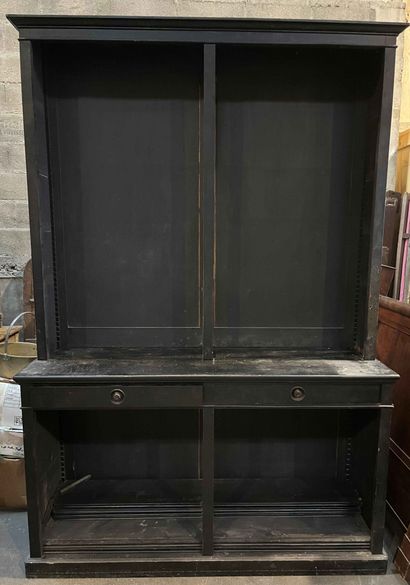 null Large two parts bookcase in blackened wood, opening with two drawers in the...