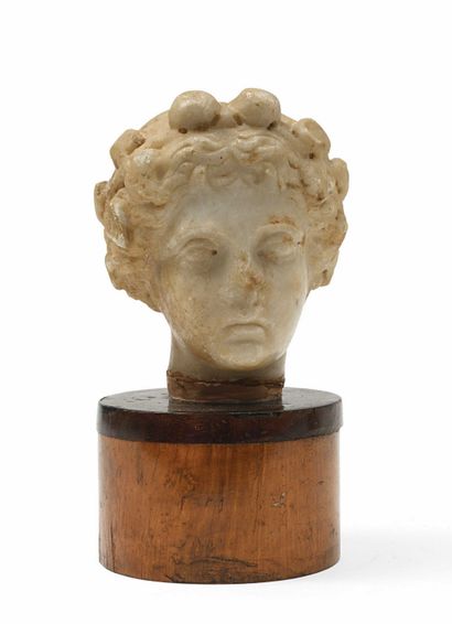 null 198 Head of a maenad whose wavy hair is gathered in a bun on either side of...
