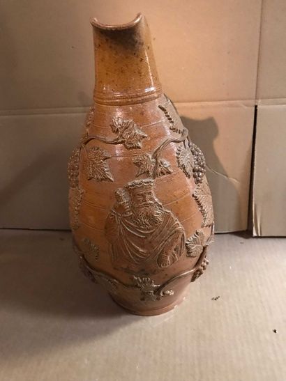 null Large stoneware pitcher decorated with grapevines and crowned character. Height:...