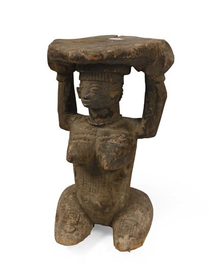 null Stool in patinated wood representing a woman holding a base on her head. Scarifications...