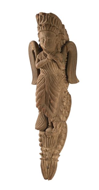 null INDIA. Carved wooden element decorated with a winged character, richly draped...