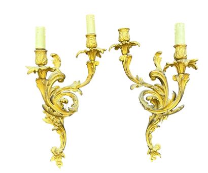 null Pair of chased ormolu sconces with two arms and foliage decoration. Louis XV...