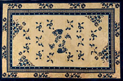 CHINE Tapis chinois en laine à décor de motifs bleus sur fond crème et bordure.
245...