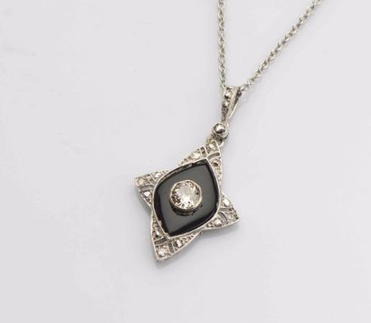 null Pendentif cruciforme en or gris 18 ct (750) orné de diamants et d’onyx, l’un...