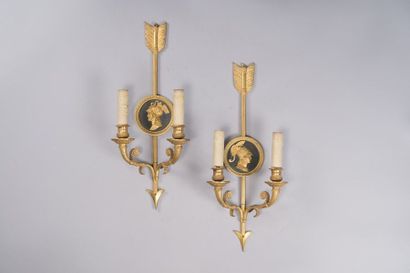 null Pair of two-armed sconces in chased and gilded bronze with arrows and medallions,...
